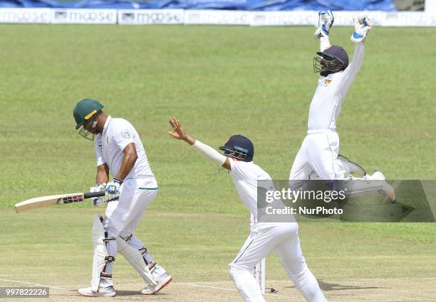 Sri Lankan wicketkeeper Niroshan Dickwella leaps in the air to appeal successfully for the dismissal of South African cricketer Vernon Philander...