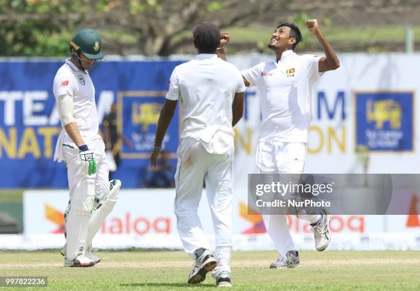 Sri Lankan cricket captain Suranga Lakmal celebrates as South African captain Faf du Plessis reacts after his dismissal during the 2nd day's play in...