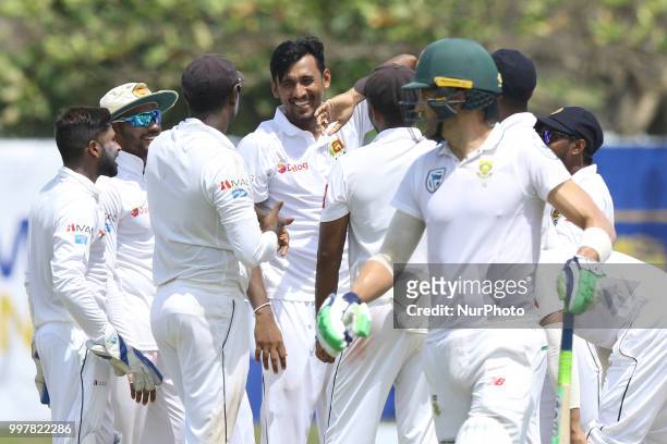Sri Lankan cricket captain Suranga Lakmal and team members celebrate as South African captain Faf du Plessis walks off after his dismissal during the...