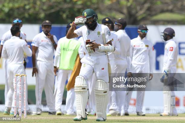 South African cricketer Hashim Amla walks off following his dismissal during the 2nd day's play in the first Test cricket match between Sri Lanka and...