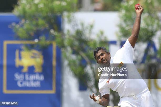 Sri Lankan cricketer Rangana Herath delivers a ball during the 2nd day's play in the first Test cricket match between Sri Lanka and South Africa at...