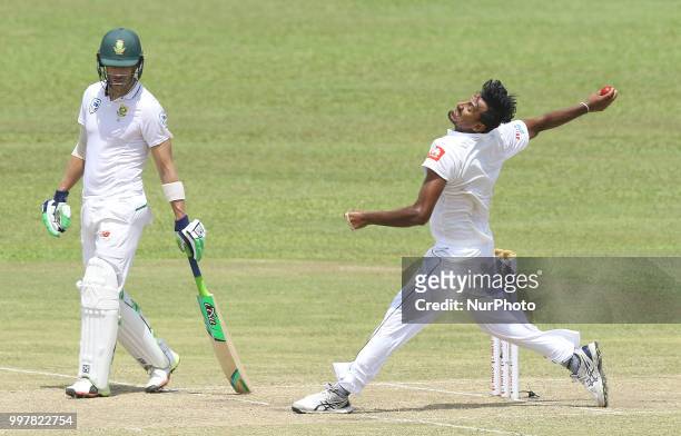 Sri Lankan cricket captain Suranga Lakmal delivers a ball as South African cricket captain Faf Du Plessis looks on during the 2nd day's play in the...