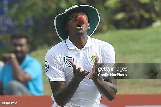 South African cricketer Kagiso Rabada takes a catch to dismiss Sri Lankan cricketer Danushka Gunathilaka during the 2nd day's play in the first Test...