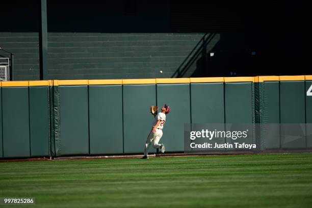 Dominic Fletcher of the Arkansas Razorbacks catches a fly ball against the Oregon State Beavers during the Division I Men's Baseball Championship...