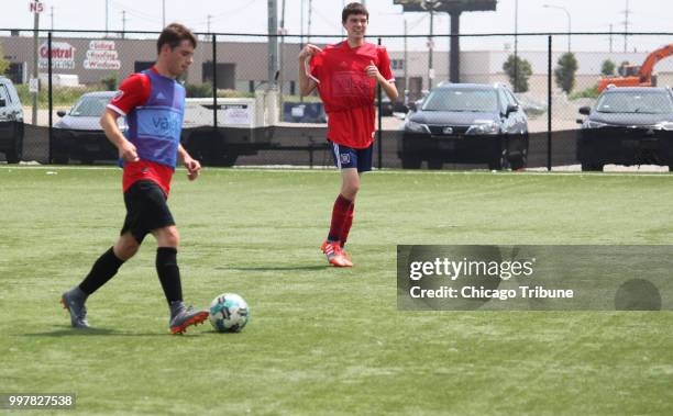 Team USA Illinois player Michael Brennan of Naperville, left, tries to drive the ball away from teammate Ryan McDonough of Aurora on Wednesday, July...