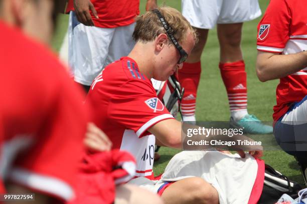 Mark Jerabek of Naperville looks at his new uniforms on Wednesday, July 11 that he'll wear with Team USA Illinois in the Special Olympics Unified Cup...