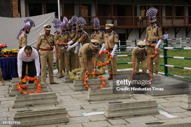 Director General of Jammu and Kashmir Police Shesh Paul Vaid along with other Indian officers offer floral tribute to 1931 martyrs during a ceremony...