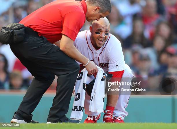 Boston Red Sox new first baseman Steve Pearce gets help after he was hit with a first inning pitch. He left the game in the second inning. The Boston...