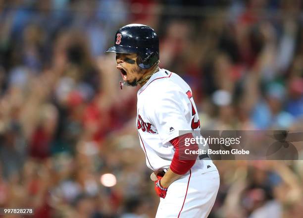 Boston Red Sox player Mookie Betts screams as he runs to first base after hitting a grand slam in the fourth inning. The Boston Red Sox host the...