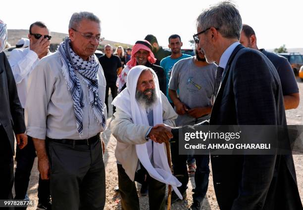 Pierre Cochard , French Consul General to Jerusalem, shakes hands with an elderly Palestinian during his visit to the Bedouin village of Khan...