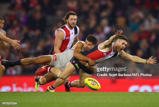 Jade Gresham of the Saints is tackled by Sam Petrevski-Seton of the Blues during the round 17 AFL match between the St Kilda Saints and the Carlton...