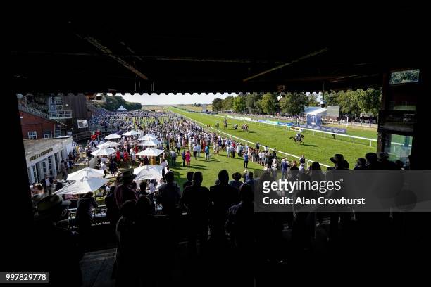General view as runners pass the winning post at Newmarket Racecourse on July 13, 2018 in Newmarket, United Kingdom.