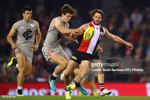Jack Steven of the Saints is tackled by Paddy Dow of the Blues during the round 17 AFL match between the St Kilda Saints and the Carlton Blues at...