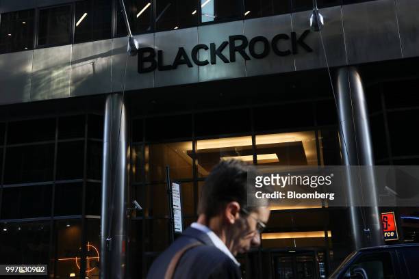 Pedestrian walks past BlackRock Inc. Headquarters in New York, U.S, on Wednesday, June 11, 2018. BlackRock Inc. Is scheduled to release earnings...