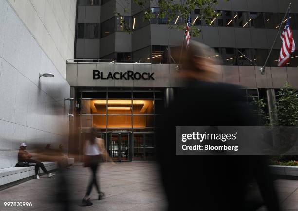 Pedestrians walk past BlackRock Inc. Headquarters in New York, U.S, on Wednesday, June 11, 2018. BlackRock Inc. Is scheduled to release earnings...