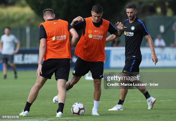 Mauro Icardi competes for the ball with Milan Skriniar during the FC Internazionale training camp at the club's training ground Suning Training...