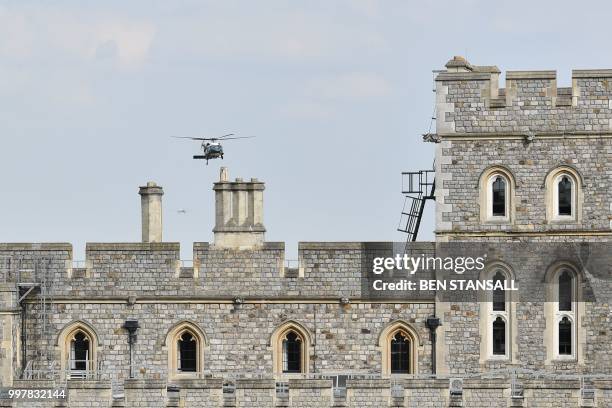 President Donald Trump and US First Lady Melania Trump arrive by helicopter at Windsor Castle in Windsor, west of London, on July 13, 2018 for an...