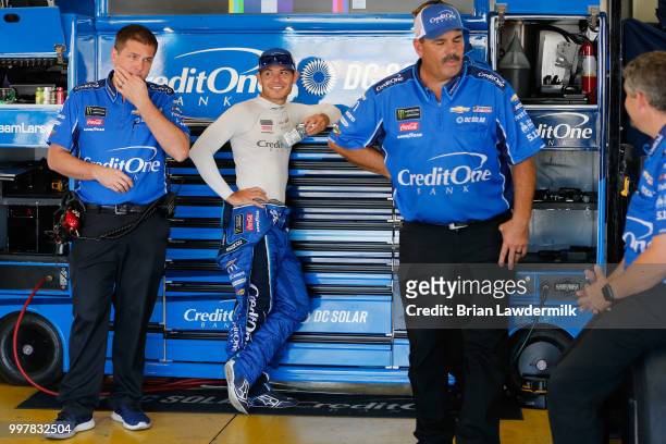 Kyle Larson, driver of the Credit One Bank Chevrolet, stands in the garage area during practice for the Monster Energy NASCAR Cup Series Quaker State...