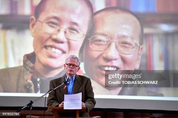 The late Chinese dissident and Nobel Peace Prize laureate Liu Xiaobo and his widow Liu Xia are seen on the screen as Pulitzer Prize-winning author...