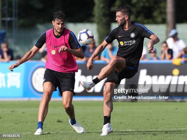 Roberto Gagliardini is challenged by Andrea Ranocchia during the FC Internazionale training camp at the club's training ground Suning Training Center...