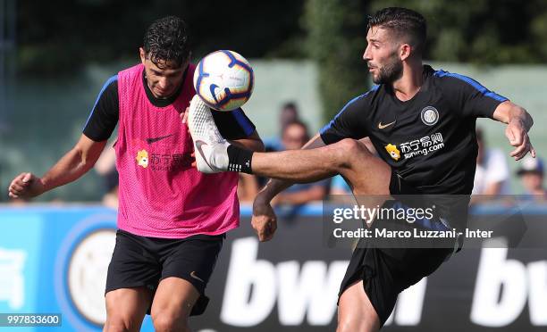 Roberto Gagliardini is challenged by Andrea Ranocchia during the FC Internazionale training camp at the club's training ground Suning Training Center...