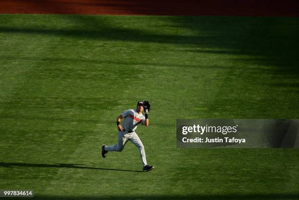 Trevor Larnach of the Oregon State Beavers catches a fly ball against the Arkansas Razorbacks during the Division I Men's Baseball Championship held...