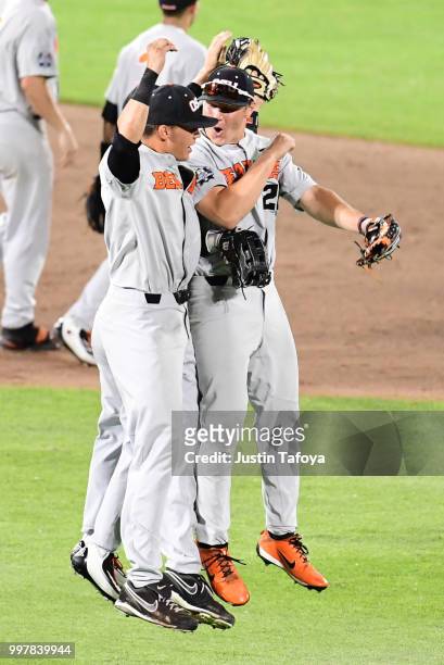 Zach Clayton and Trevor Larnach of the Oregon State Beavers celebrate winning game two against the Arkansas Razorbacks during the Division I Men's...