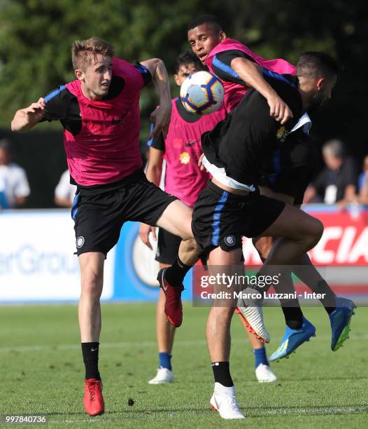 Henrique Dalbert is challenged by Ryan Patrick Nolan and Roberto Gagliardini during the FC Internazionale training camp at the club's training ground...