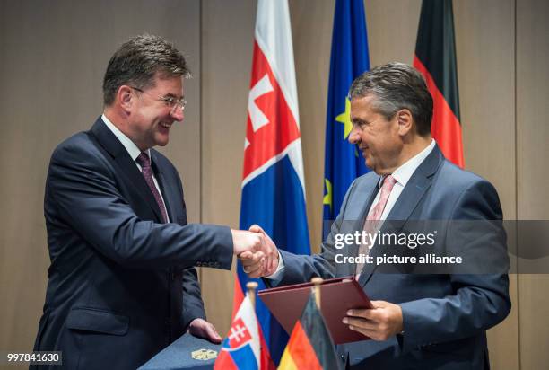 The Slovakian Foreign Minister Miroslav Lajcak and the German Foreign Minister Sigmar Gabriel are shaking hands after signing a statement to deepen...