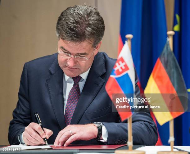 The Slovakian Foreign Minister Miroslav Lajcak signs a statement to deepen the dialogue with the German Foreign Minister Sigmar Gabriel in Wolfsburg,...