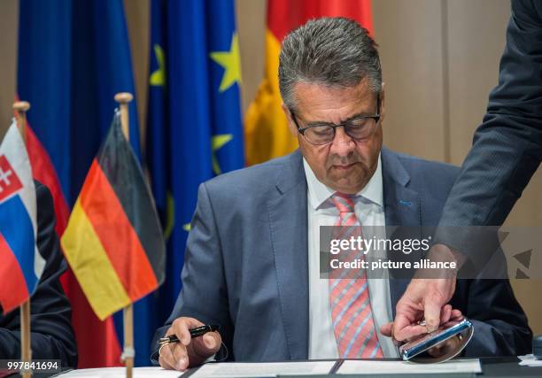 The German Foreign Minister Sigmar Gabriel signs a statement to deepen the dialogue with the Slovakian Foreign Minister Miroslav Lajcak in Wolfsburg,...
