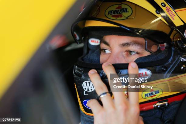 Joey Logano, driver of the Shell Pennzoil Ford, stands in the garage area during practice for the Monster Energy NASCAR Cup Series Quaker State 400...