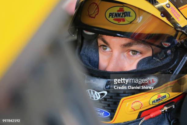 Joey Logano, driver of the Shell Pennzoil Ford, stands in the garage area during practice for the Monster Energy NASCAR Cup Series Quaker State 400...