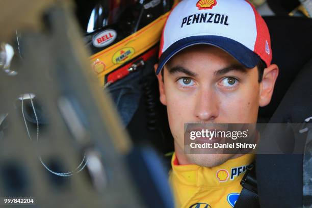 Joey Logano, driver of the Shell Pennzoil Ford, stands in the garage area during practice for the Monster Energy NASCAR Cup Series Quaker State 400...