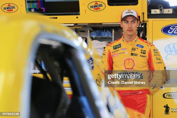 Joey Logano, driver of the Shell Pennzoil Ford, stands in the garage area during practice for the Monster Energy NASCAR Cup Series Quaker State 400...