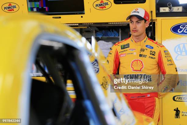 Joey Logano, driver of the Shell Pennzoil Ford, stands in the garage area during practice for the Monster Energy NASCAR Cup Series Quaker State 400...