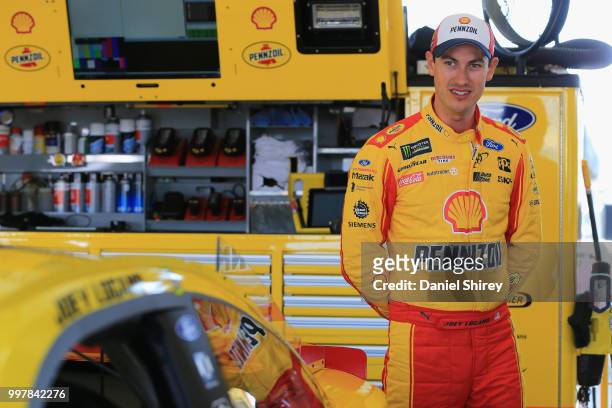 Joey Logano, driver of the Shell Pennzoil Ford, stands in the garage area during practice for the Monster Energy NASCAR Cup Series Quaker State 400...