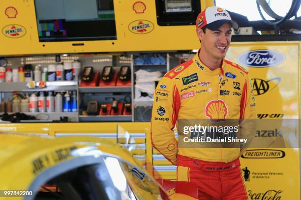 Joey Logano, driver of the Shell Pennzoil Ford, stands in the garage area during practice for the Monster Energy NASCAR Cup Series Quaker State 400...