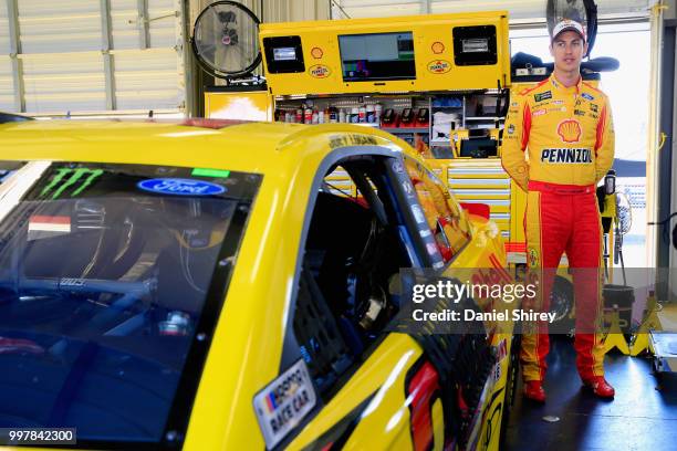 Joey Logano, driver of the Shell Pennzoil Ford, stands in the garage area during practice for the Monster Energy NASCAR Cup Series Quaker State 400...