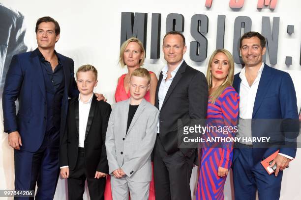 British actor Henry Cavill poses for a photograph with members of his family as he arrives for the UK premiere of the film Mission: Impossible -...