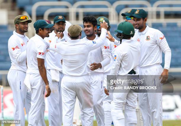 Mehidy Hasan Miraz of Bangladesh congratulated by teammates after taking 5 West Indies wickets for 93 runs during day 2 of the 2nd Test between West...