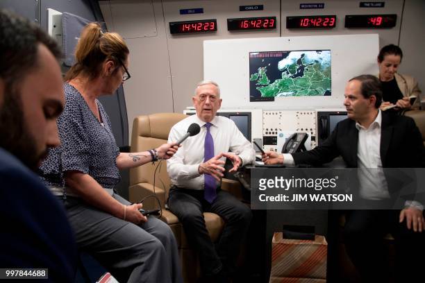 Secretary of Defence James Mattis briefs reporters on the plane from Zagreb to Olso on July 13, 2018. - Mattis travels to Oslo to attend bilateral...