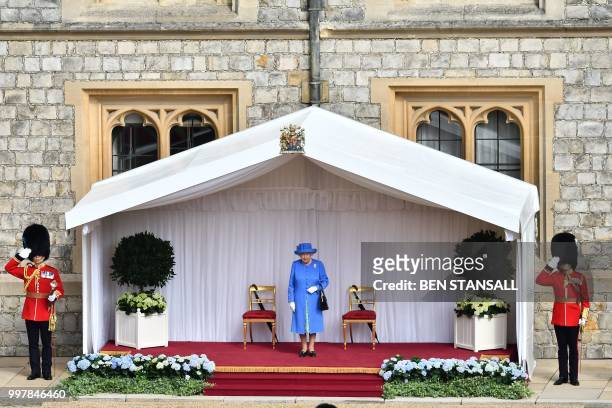 Britain's Queen Elizabeth II stands on the dias waiting the receive US President Donald Trump and US First Lady Melania Trump during a ceremonial...