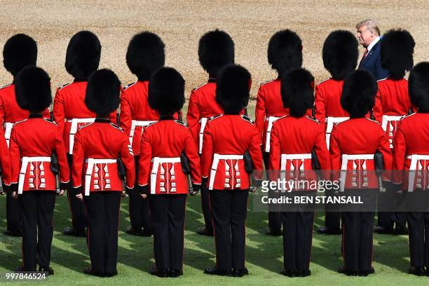 Britain's Queen Elizabeth II and US President Donald Trump inspect the guard of honour formed of the Coldstream Guards during a welcome ceremony at...