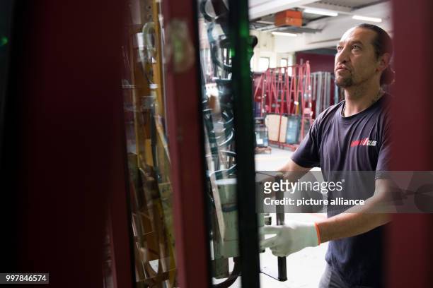 Basir Mirkhani from Afghanistan operates machinery in the workshops of Energy Glas in Wolfshagen, Germany, 4 August 2017. The glass manufacturer is...