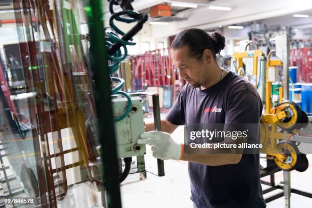 Basir Mirkhani from Afghanistan operates machinery in the workshops of Energy Glas in Wolfshagen, Germany, 4 August 2017. The glass manufacturer is...