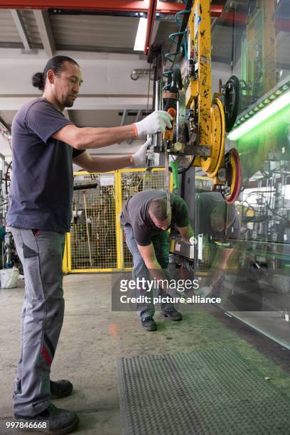 Basir Mirkhani from Afghanistan and Heiko Kahle in the workshops of Energy Glas in Wolfshagen, Germany, 4 August 2017. The glass manufacturer is...