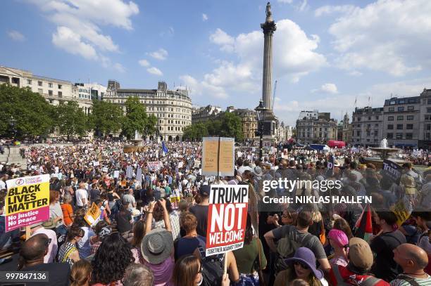 Trafalgar Square is filled with protesters against the UK visit of US President Donald Trump holding up placards as they take part in a march and...