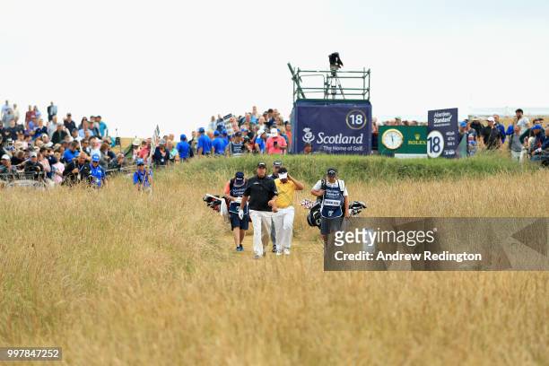 Phil Mickelson of USA and Kiradech Aphibarnrat of Thailand walk on hole eighteen during day two of the Aberdeen Standard Investments Scottish Open at...
