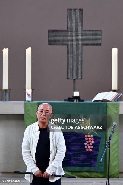 Chinese exiled writer Liao Yiwu holds a flute after performing at a commemoration for late Chinese dissident and Nobel Peace Prize laureate Liu...